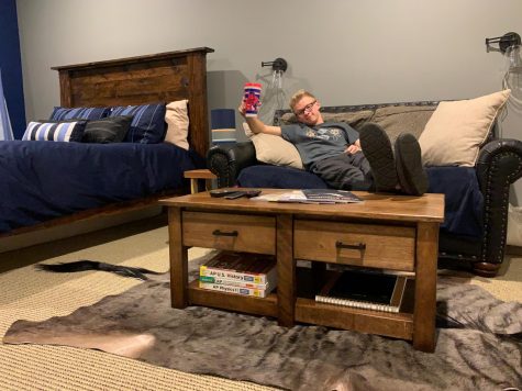 Boyden poses with a piece of furniture that he made himself. He has created new pieces during quarantine.