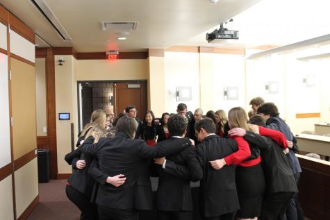 The team huddles together before the start of the competition, a tradition they participated in at Districts as well. The team got second place at Districts, but were able to take first place at State.